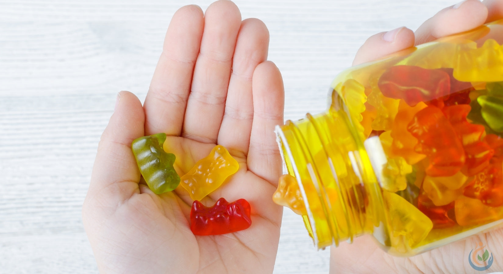 Colorful gummy vitamins in a clear plastic jar being poured into small Childs hand